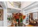 Elegant foyer showcasing a staircase with decorative iron railing and an arrangement of flowers at 1037 Windermere Xing, Cumming, GA 30041