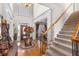 Grand foyer featuring a staircase, hardwood floors, and elegant decor at 1037 Windermere Xing, Cumming, GA 30041