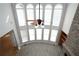 Bright great room with tall arched windows, stone fireplace, and wood floors at 1037 Windermere Xing, Cumming, GA 30041