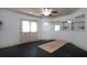 Spacious gym area with black floors, mirrors, double doors, and a ceiling fan at 1037 Windermere Xing, Cumming, GA 30041
