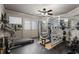 Home gym with weightlifting equipment, mirrors, and rubber flooring at 1037 Windermere Xing, Cumming, GA 30041