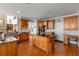 Spacious kitchen with a center island, wooden cabinets, granite countertops and hardwood floors at 1037 Windermere Xing, Cumming, GA 30041