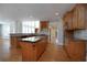 Spacious kitchen with wooden cabinetry, granite countertops, and stainless steel appliances at 1037 Windermere Xing, Cumming, GA 30041