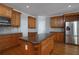 Eat-in kitchen features wooden cabinetry, granite countertops and stainless steel appliances at 1037 Windermere Xing, Cumming, GA 30041