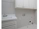 Laundry room with sink, white cabinets, and washer/dryer hookups at 1037 Windermere Xing, Cumming, GA 30041