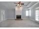 Spacious living room with a stone fireplace, coffered ceiling, and ample natural light at 1037 Windermere Xing, Cumming, GA 30041