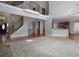 Open-concept living area with staircase, kitchen view, and hardwood flooring at 1037 Windermere Xing, Cumming, GA 30041