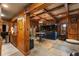 Cozy living room featuring wood-paneled walls, beams, a large aquarium, and stylish furniture at 1037 Windermere Xing, Cumming, GA 30041
