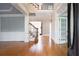 Spacious living room with hardwood floors, elegant trim, and staircase leading to upper level at 1037 Windermere Xing, Cumming, GA 30041