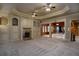 Entertainment room with fireplace, built-in storage, wood columns and carpet flooring at 1037 Windermere Xing, Cumming, GA 30041