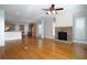 Inviting open-concept living room and kitchen with hardwood floors and stone fireplace at 1037 Windermere Xing, Cumming, GA 30041