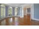 Bright living room featuring hardwood floors, large windows, and classic French doors at 1037 Windermere Xing, Cumming, GA 30041