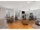 Open floor plan with living and dining areas featuring hardwood floors and a decorative stone fireplace at 1037 Windermere Xing, Cumming, GA 30041