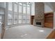 Bright and airy living room with a floor-to-ceiling stone fireplace and expansive windows at 1037 Windermere Xing, Cumming, GA 30041