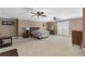 Large main bedroom with ceiling fans, neutral walls, and access to outdoor balcony at 1037 Windermere Xing, Cumming, GA 30041