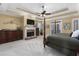 Spacious main bedroom with fireplace, ceiling fan, and access to private balcony at 1037 Windermere Xing, Cumming, GA 30041