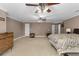 Expansive main bedroom with neutral tones, ceiling fans, and access to outdoor balcony at 1037 Windermere Xing, Cumming, GA 30041
