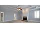 The main bedroom offers a stone fireplace, trey ceiling and an abundance of natural light at 1037 Windermere Xing, Cumming, GA 30041