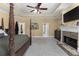 Large primary bedroom features a fireplace, tv, trey ceiling, four poster bed and ceiling fan at 1037 Windermere Xing, Cumming, GA 30041