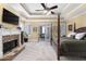 Bright primary bedroom offers a fireplace, trey ceiling, backyard access, and four poster bed at 1037 Windermere Xing, Cumming, GA 30041