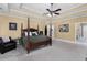 Large main bedroom with four poster bed, tray ceiling, and an ensuite bathroom at 1037 Windermere Xing, Cumming, GA 30041