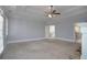Large main bedroom featuring a tray ceiling, carpet flooring, fireplace, and neutral paint at 1037 Windermere Xing, Cumming, GA 30041