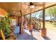 Inviting covered patio with brick accents, ceiling fans and stairs to upper deck with scenic views at 1037 Windermere Xing, Cumming, GA 30041
