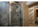 Tiled glass shower with brushed metal finishings and neutral toned walls at 1037 Windermere Xing, Cumming, GA 30041