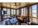 Cozy sunroom with lots of windows, ceiling fan, comfortable seating, and slate floors at 1037 Windermere Xing, Cumming, GA 30041