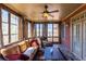 Cozy sunroom with lots of windows, ceiling fan, comfortable seating, and slate floors at 1037 Windermere Xing, Cumming, GA 30041