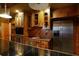 Wet bar features wood cabinetry with glass inserts and stainless steel refrigerator at 1037 Windermere Xing, Cumming, GA 30041