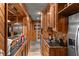 This wet bar features wood paneled walls and cabinetry with a granite counter top at 1037 Windermere Xing, Cumming, GA 30041