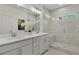 Bright bathroom with double vanity, large mirror, quartz countertops, and walk-in shower at 1283 Forsyth Park Rd, Decatur, GA 30033