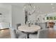Bright dining area features a modern chandelier and open-concept design to the kitchen at 1283 Forsyth Park Rd, Decatur, GA 30033