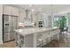 A bright, spacious kitchen featuring stainless steel appliances and a large island with bar seating at 1283 Forsyth Park Rd, Decatur, GA 30033