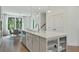 Open kitchen with a large island featuring a sink, dishwasher, storage shelves, and pendant lighting at 1283 Forsyth Park Rd, Decatur, GA 30033
