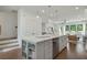 Open kitchen with a large island featuring a sink, dishwasher, and storage shelves at 1283 Forsyth Park Rd, Decatur, GA 30033