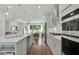Gourmet kitchen with stainless appliances, stone countertops, large island, and an open view to the living room at 1283 Forsyth Park Rd, Decatur, GA 30033
