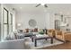 Bright living room with stylish decor, hardwood floors, and a view to the kitchen at 1283 Forsyth Park Rd, Decatur, GA 30033