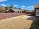 A spacious backyard featuring a brown wooden fence and a small concrete patio at 1705 Rolling View Dr, Cumming, GA 30040