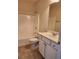 Cozy bathroom featuring a tub and shower combo and a single sink vanity with a large mirror at 1705 Rolling View Dr, Cumming, GA 30040