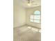 Light-filled bedroom featuring neutral carpet and an arched window at 1705 Rolling View Dr, Cumming, GA 30040