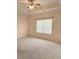 Spacious bedroom featuring a ceiling fan and a large window with blinds at 1705 Rolling View Dr, Cumming, GA 30040