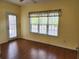A bright bedroom featuring hardwood floors, a large window, and a door to the outside at 1705 Rolling View Dr, Cumming, GA 30040
