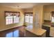 A view of a dining area boasting hardwood floors, large windows, and an adjacent island at 1705 Rolling View Dr, Cumming, GA 30040