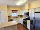 Well-lit kitchen with stainless appliances, wooden floors, and a center island at 1705 Rolling View Dr, Cumming, GA 30040