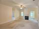 Cozy living room with carpeted floors, a ceiling fan, and a fireplace with a decorative mantel at 1705 Rolling View Dr, Cumming, GA 30040