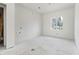 Unfinished bedroom with a large window providing ample natural light at 2650 Roswell Rd, Marietta, GA 30062