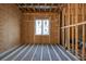 Unfinished bedroom with wooden beams, walls, and a window at 2650 Roswell Rd, Marietta, GA 30062