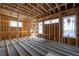 Bright living room under construction featuring wooden framing, exposed beams and three large windows at 2650 Roswell Rd, Marietta, GA 30062